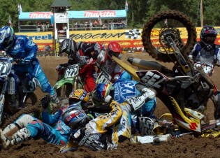 In this photo provided by AMA Pro Racing, Tanner Reidman (733), of Bismarck, N.D., Brett Metcalfe (123), of Australia, and Ryan Sipes (yellow helmet), of Vine Grove, Ky., are among a group of riders to go down in a pileup crash Sunday in the first turn of the AMA 125cc Motocross Championship round in Millville, Minn. None of the riders suffered major injuries in the crash. Reidman, Metcalfe and Sipes all re-entered the race. (AP Photo/AMA Pro Racing, Larry Lawrence)